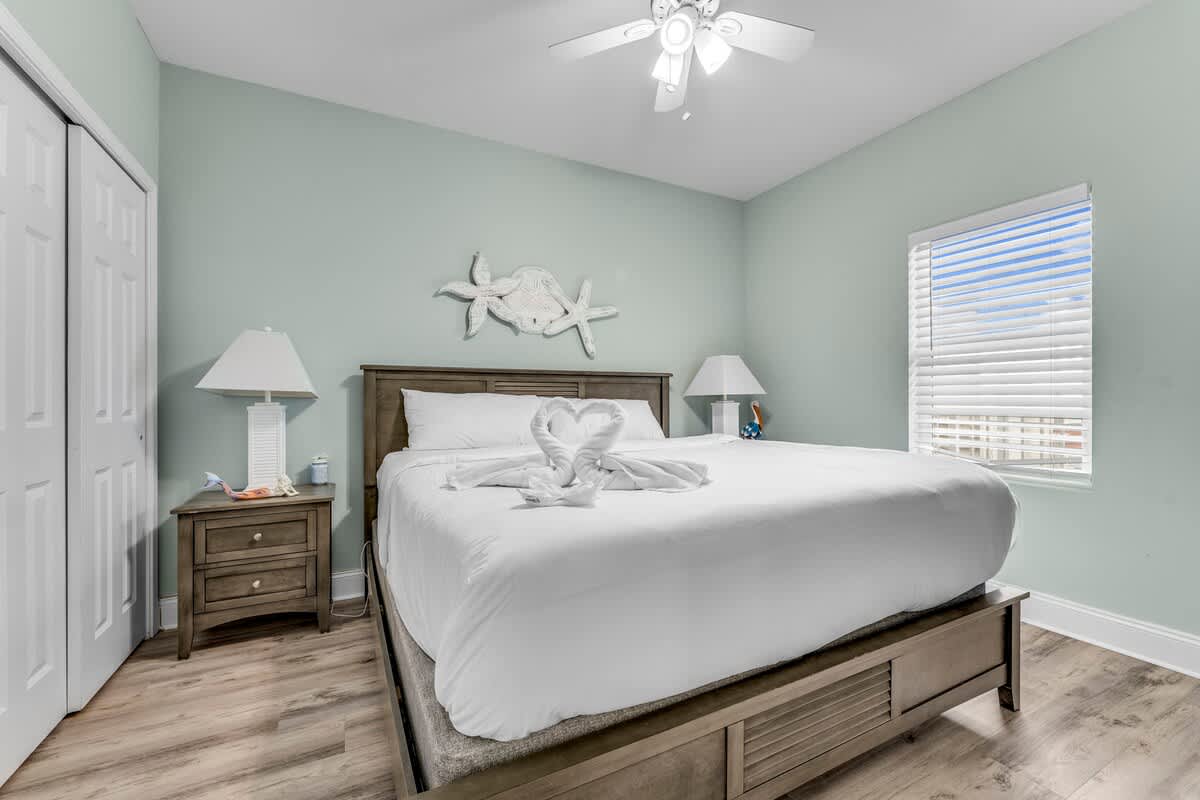 Laketown Wharf 1331 – Cozy bedroom with a king bed, nightstands, and window with blinds.