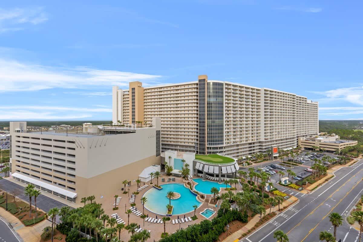 Laketown Wharf 1331 – Aerial view of Laketown Wharf with large pools, palm trees, and surrounding buildings.