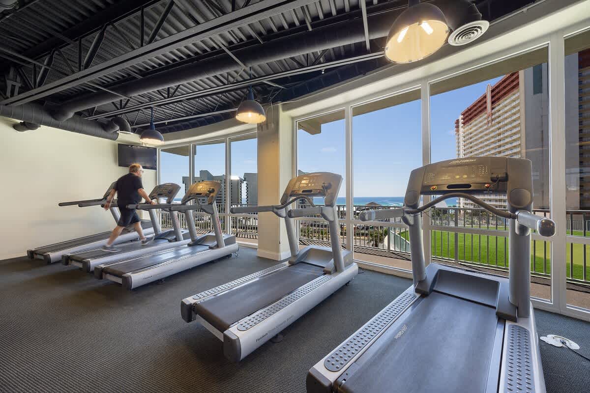 Laketown Wharf 1331 – Fitness room with treadmills and large windows showing ocean view.
