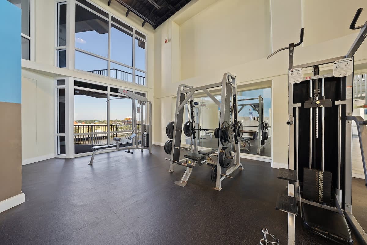 Laketown Wharf 1331 – Gym with weight machines and large windows showing a view outside.