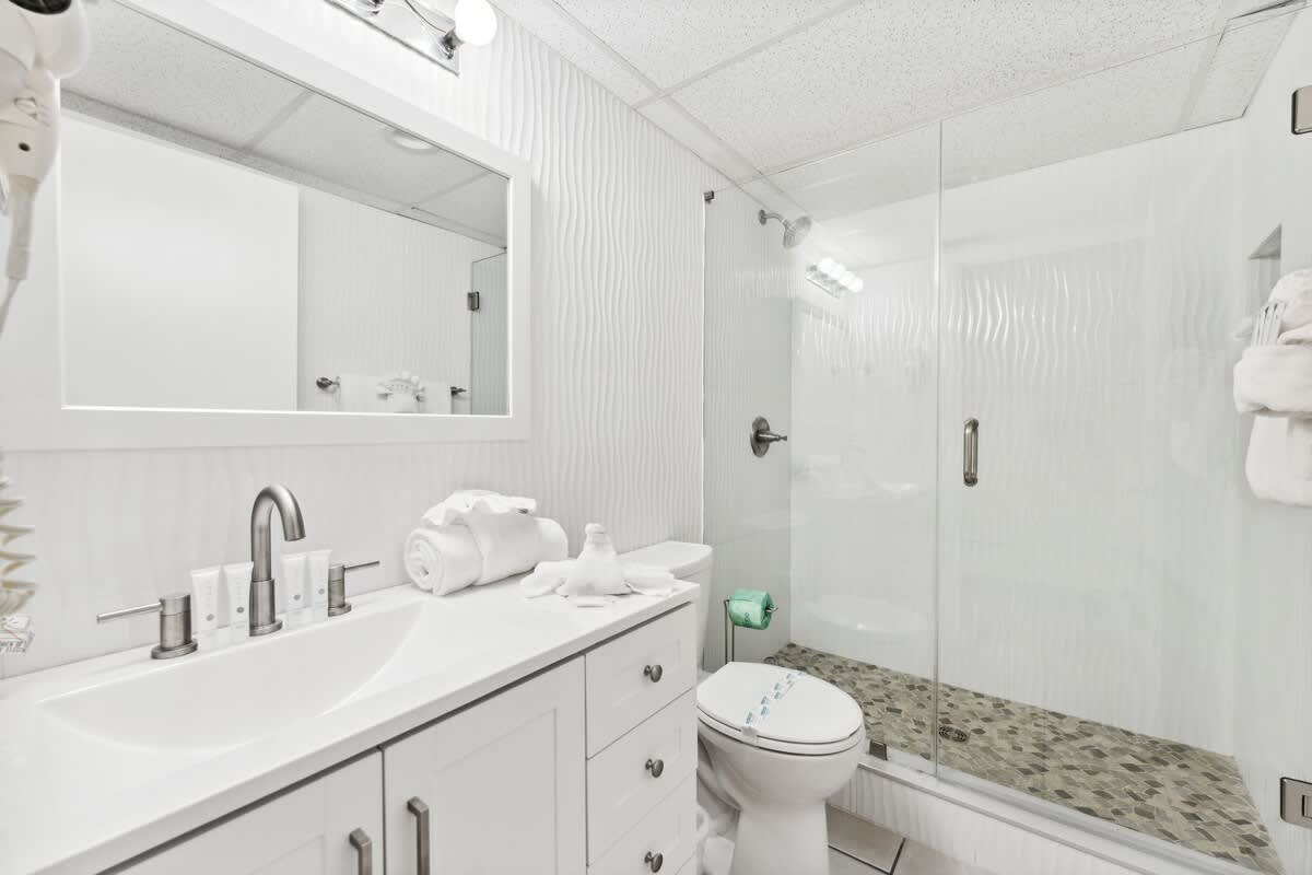 Moondrifter 608 – Modern bathroom with a walk-in shower, double sink, and neutral decor.