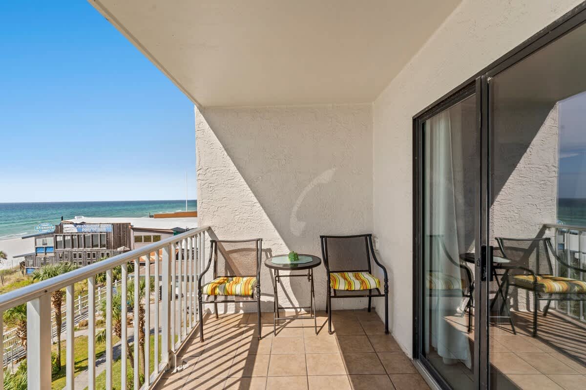 The Summit 506 – Balcony with two chairs and a table, overlooking the beach and ocean view.