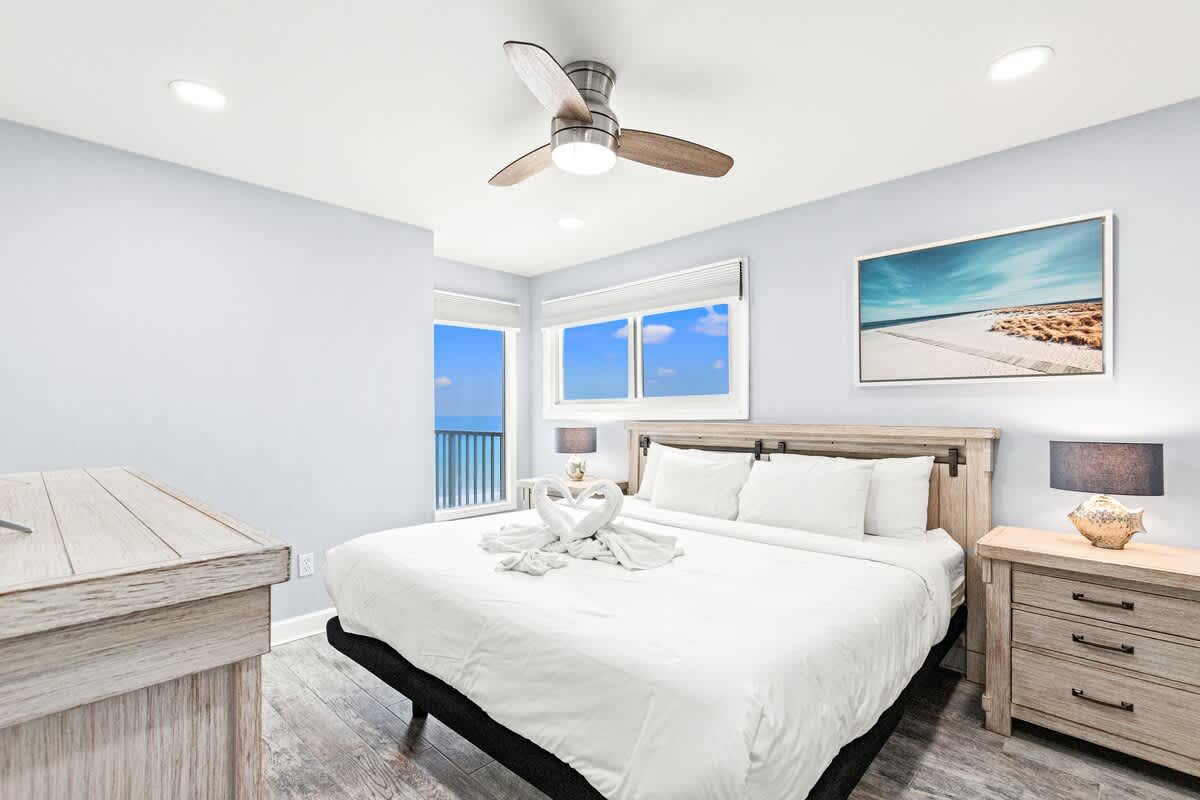 The Summit 701 – Cozy bedroom with a king bed, window views of the ocean, and modern decor.