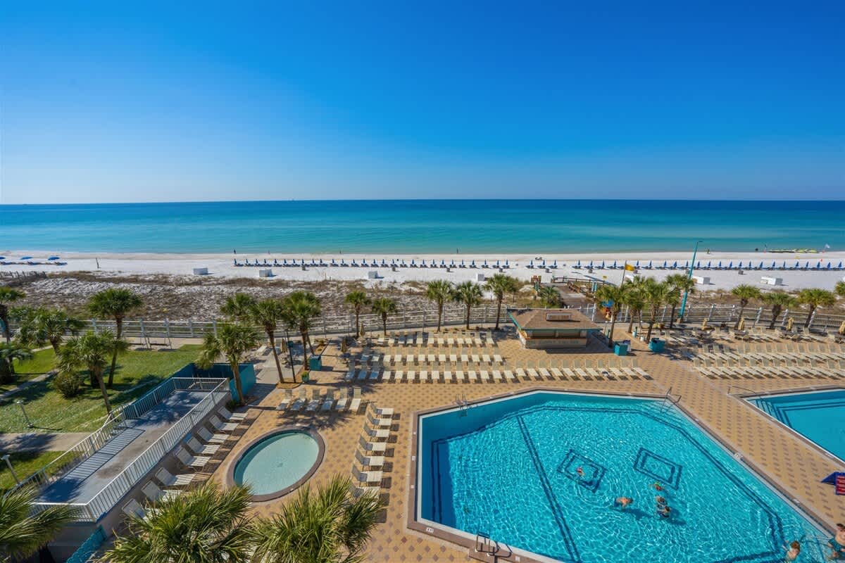 The Summit 621 – View of a beach, pools, and lounge chairs from a high balcony at The Summit 621.
