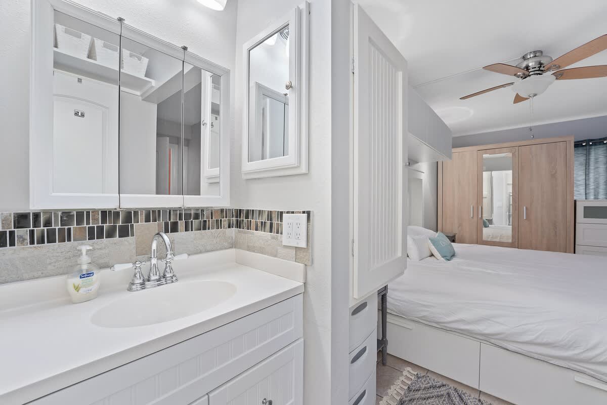 The Summit 624 – Bathroom and bedroom with a vanity, mirrors, and built-in storage.