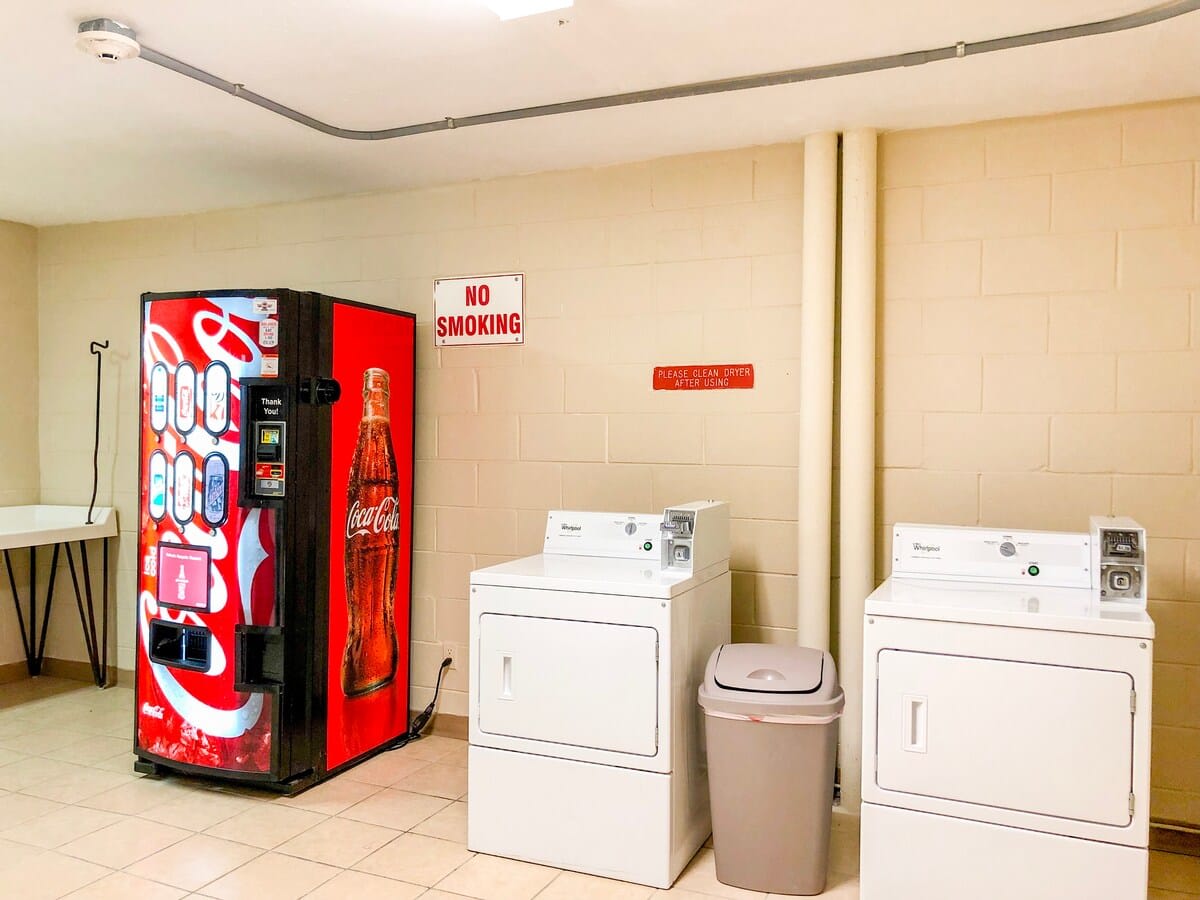 Top Of The Gulf 213 – Laundry room with washers, dryer, vending machine, and no smoking sign.