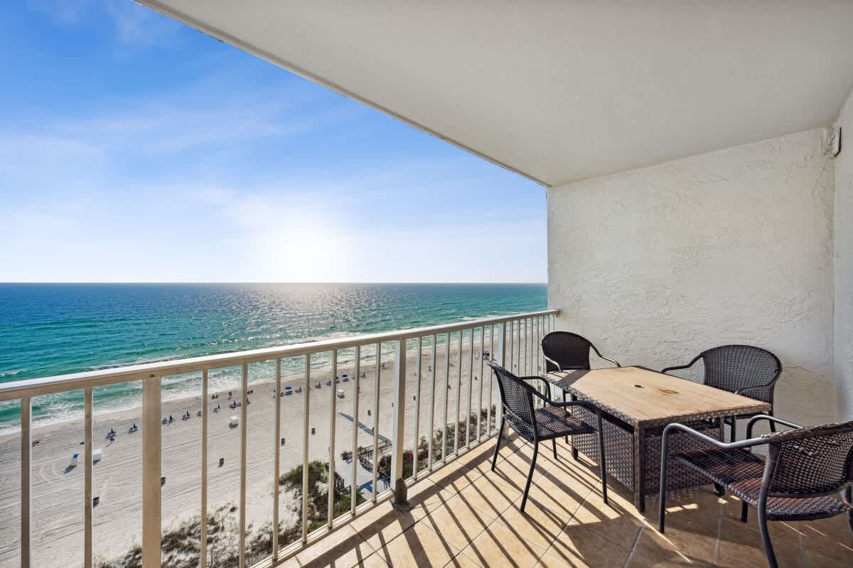 The Summit 1322 – Balcony with dining table and chairs overlooking the beach and ocean.