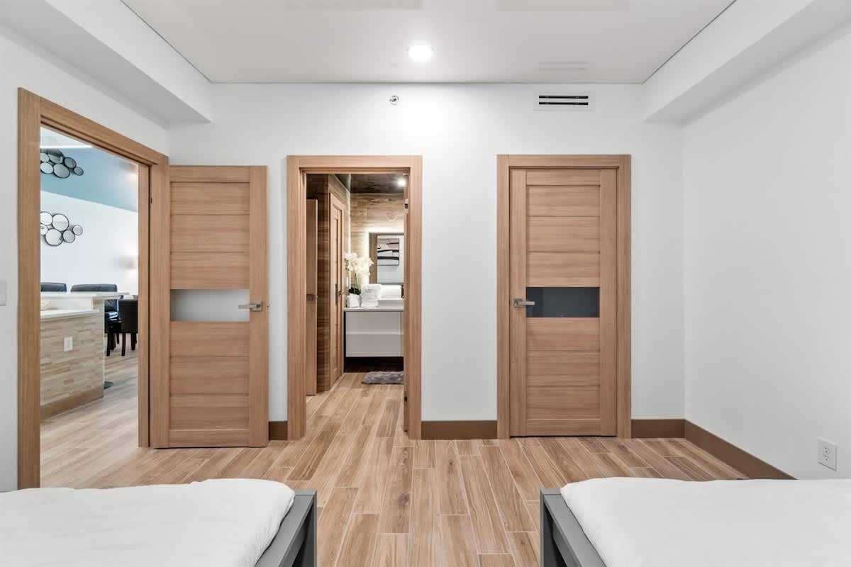 Ocean Villa 1302 – Interior view of a vacation rental with two bedrooms and a bathroom doorway visible.