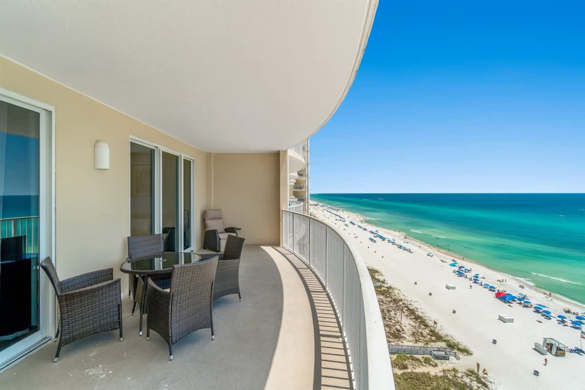 Ocean Villa 1302 – Balcony with wicker furniture overlooking beach and ocean view.