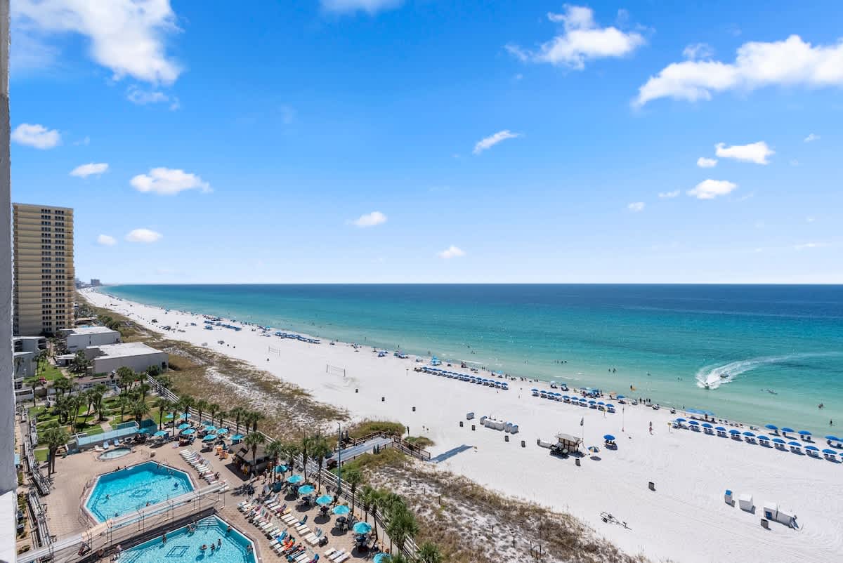 The Summit 1205 – View of beach, turquoise water, and swimming pools from balcony of vacation rental at The Summit 1205.