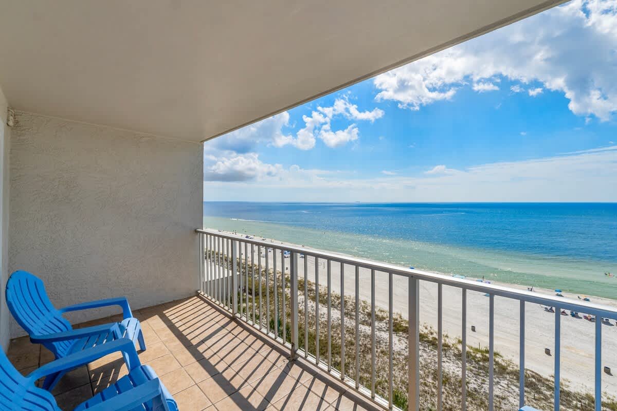 The Summit 1123 – Balcony with blue chairs and panoramic ocean view.