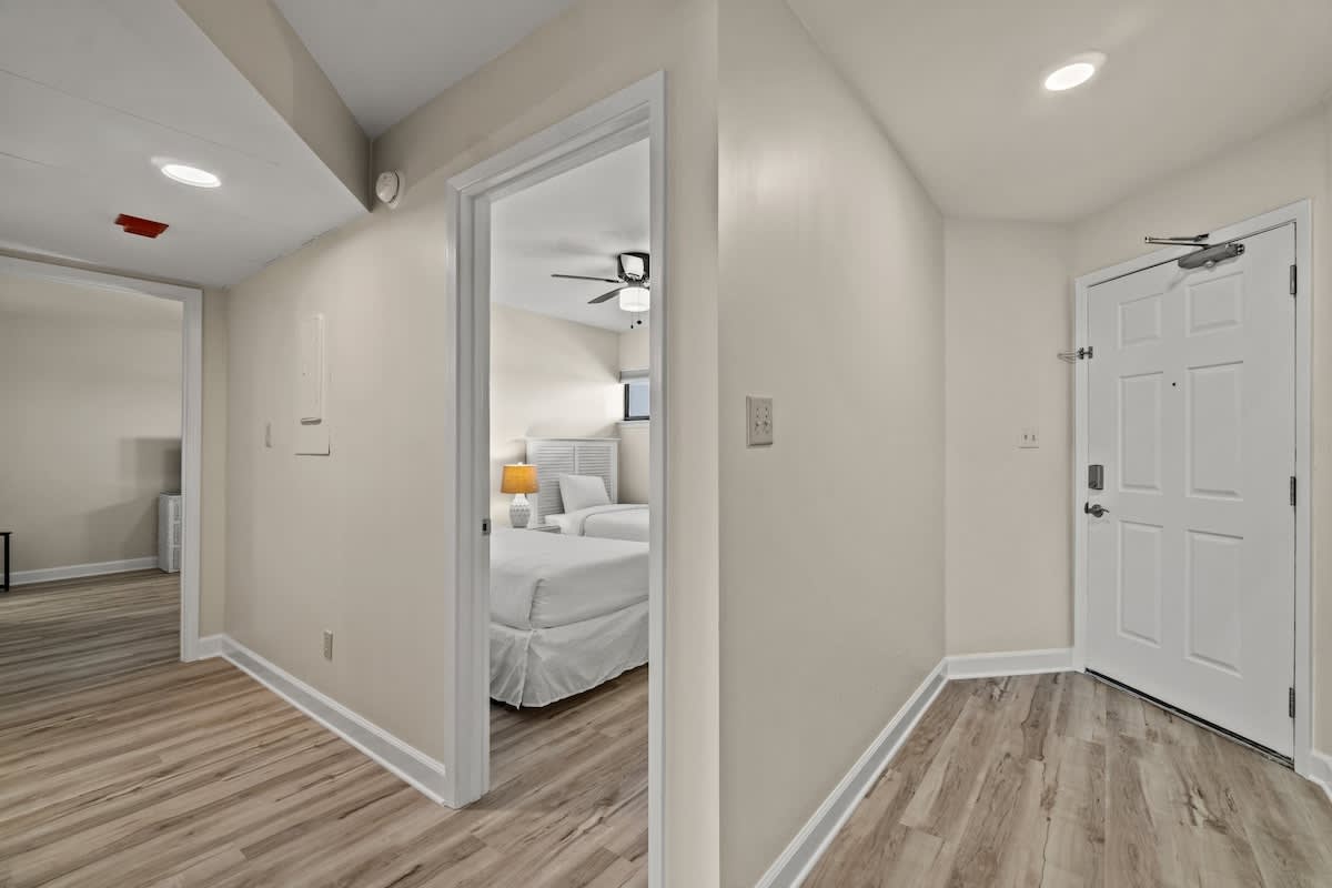 Aquavista 804E – Interior hallway leading to a bedroom, featuring light-colored walls and wood-style flooring.