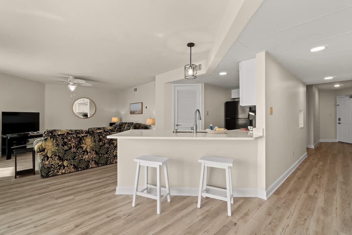 Aquavista 804E – Open living area with a kitchen bar, seating, and a view into the space.