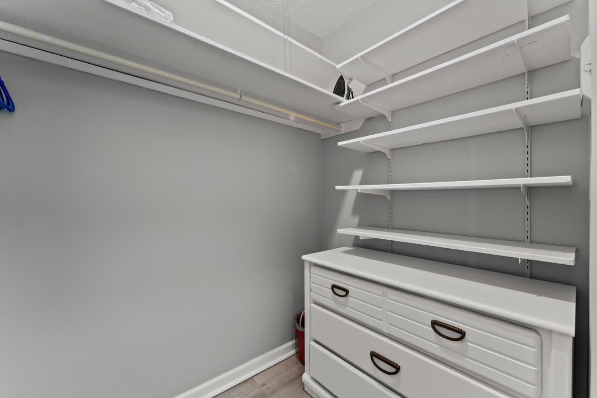 Top Of The Gulf 306 – Interior closet space with shelves and a white dresser.