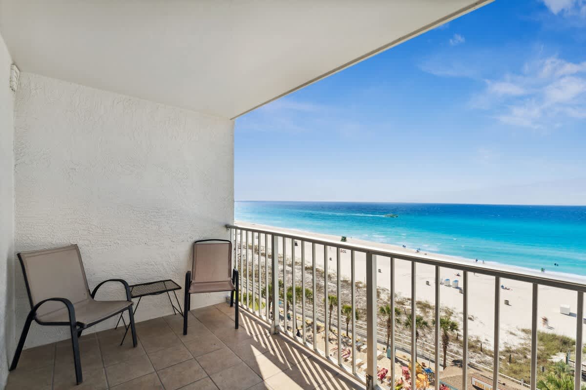 The Summit 817 – Balcony with two chairs overlooking beach and ocean views.