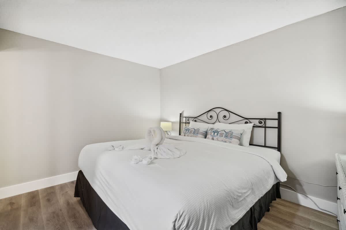 Moondrifter 502 – Cozy bedroom with a queen bed, decorative pillows, and a soft towel sculpture on the bed.