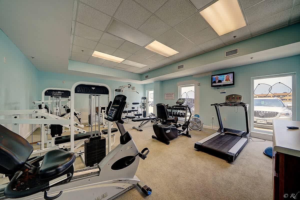 Seychelles 205 – Fitness room with exercise equipment and windows showing an outdoor view.