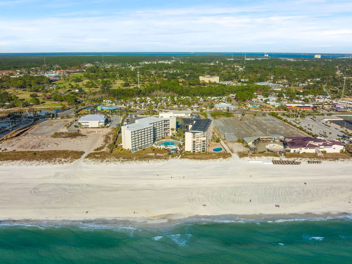 Top Of The Gulf 613 – Aerial view of Top Of The Gulf 613, beachfront location, pool area, and surrounding landscape.