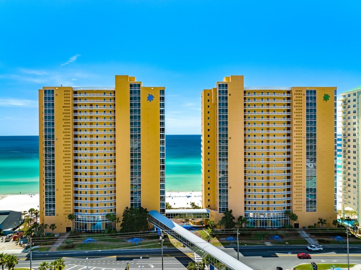 Splash 804E – View of two tall yellow buildings with ocean in the background and a beach area visible.