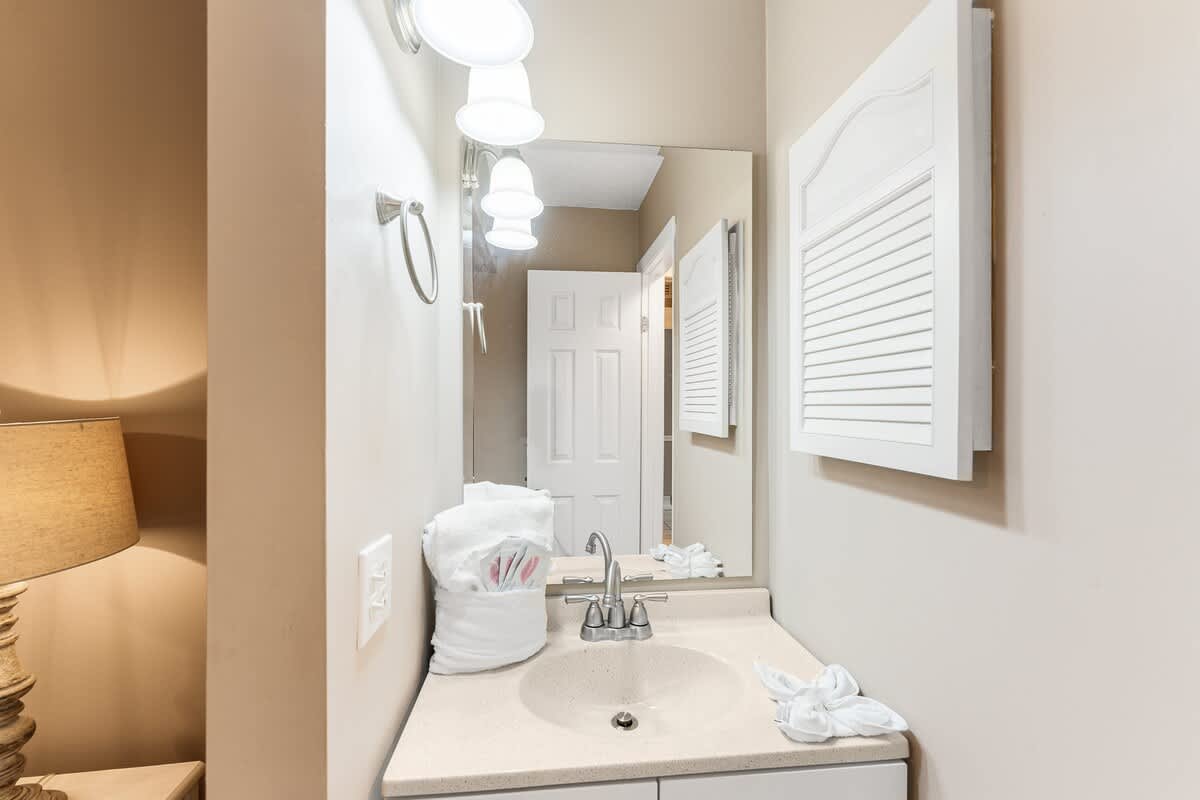 The Summit 927 – Bathroom with a sink, mirror, towel, and light fixtures.