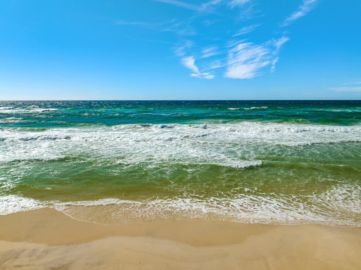 The Summit 1001 – Ocean view with turquoise waters and sandy beach under a clear blue sky.