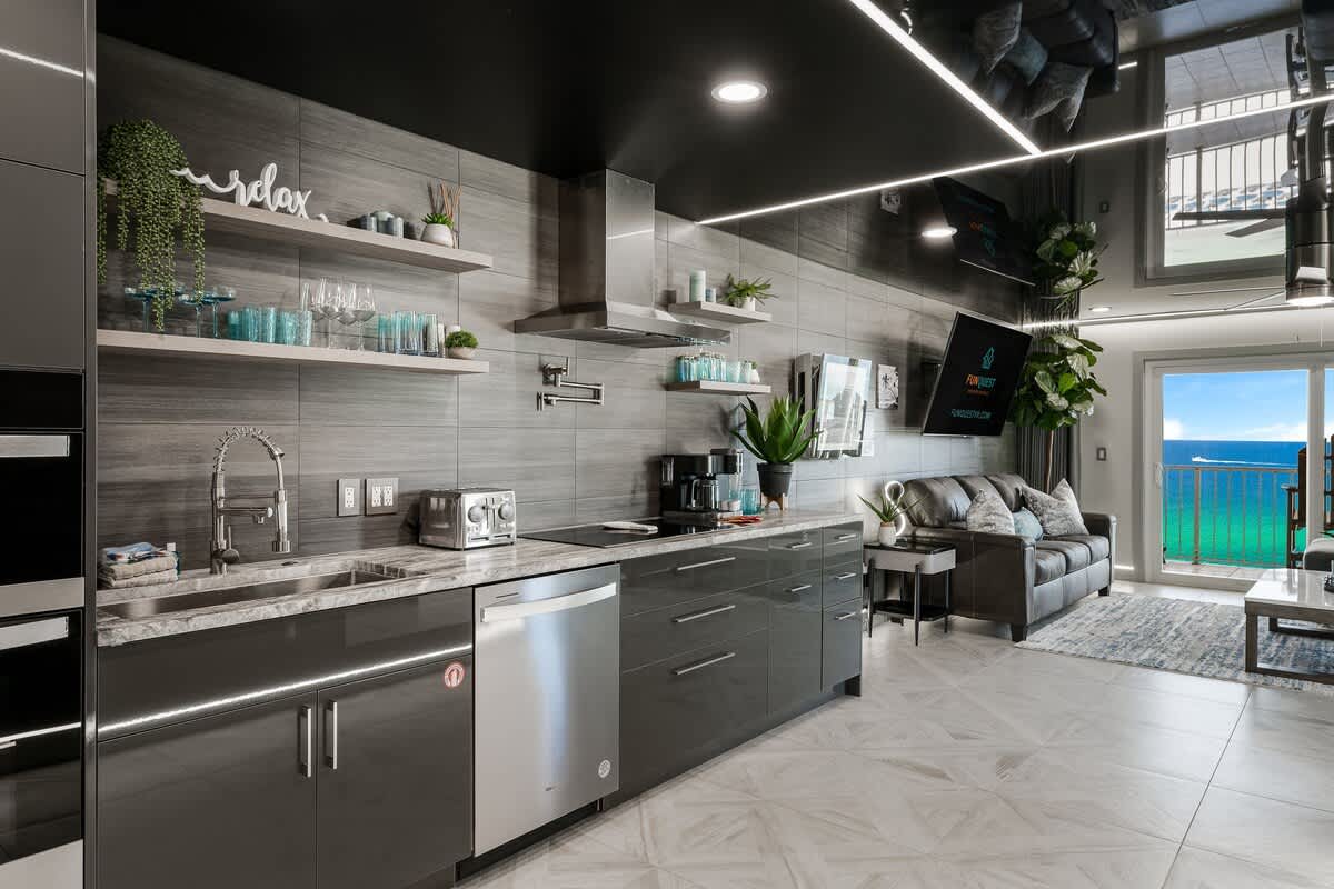 The Summit 1001 – Modern kitchen and living area with ocean view, sleek appliances, and comfortable seating.