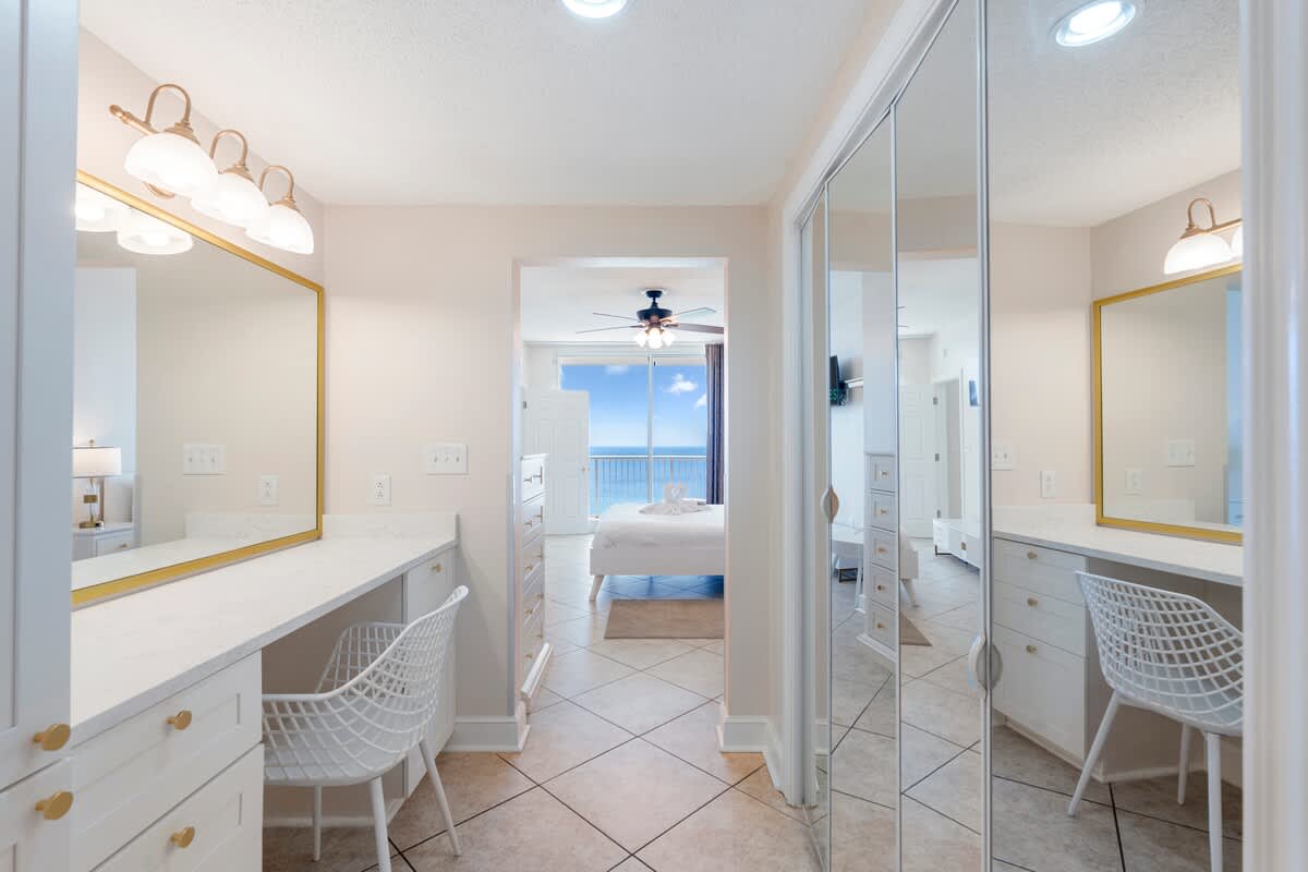 Majestic T2 - 1606 – Bright room with a vanity, mirror, and view of the ocean through a large window.