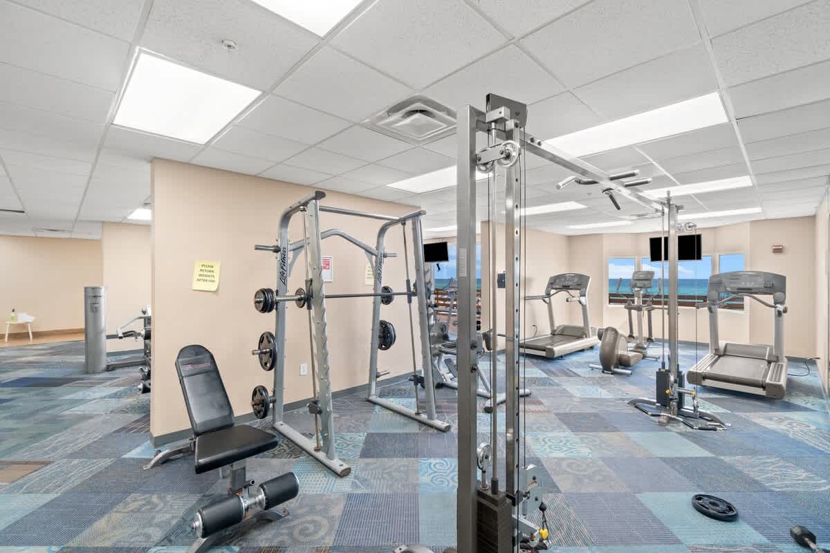 Tidewater 2615 – Fitness center with exercise equipment and ocean view windows.