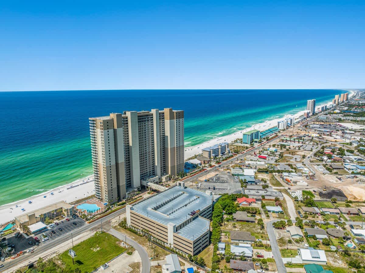 Tidewater 2615 – Aerial view of Tidewater building, beach, ocean, and nearby coastal development.