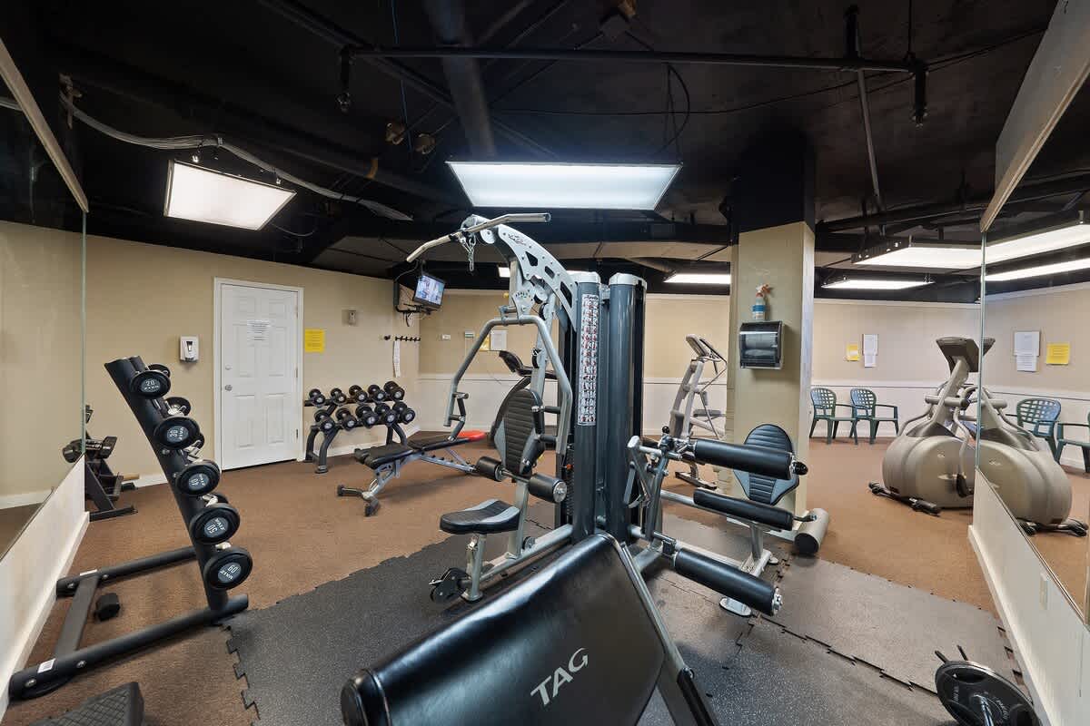 Dunes C605 – Fitness center with weight machines, dumbbells, and cardiovascular equipment.