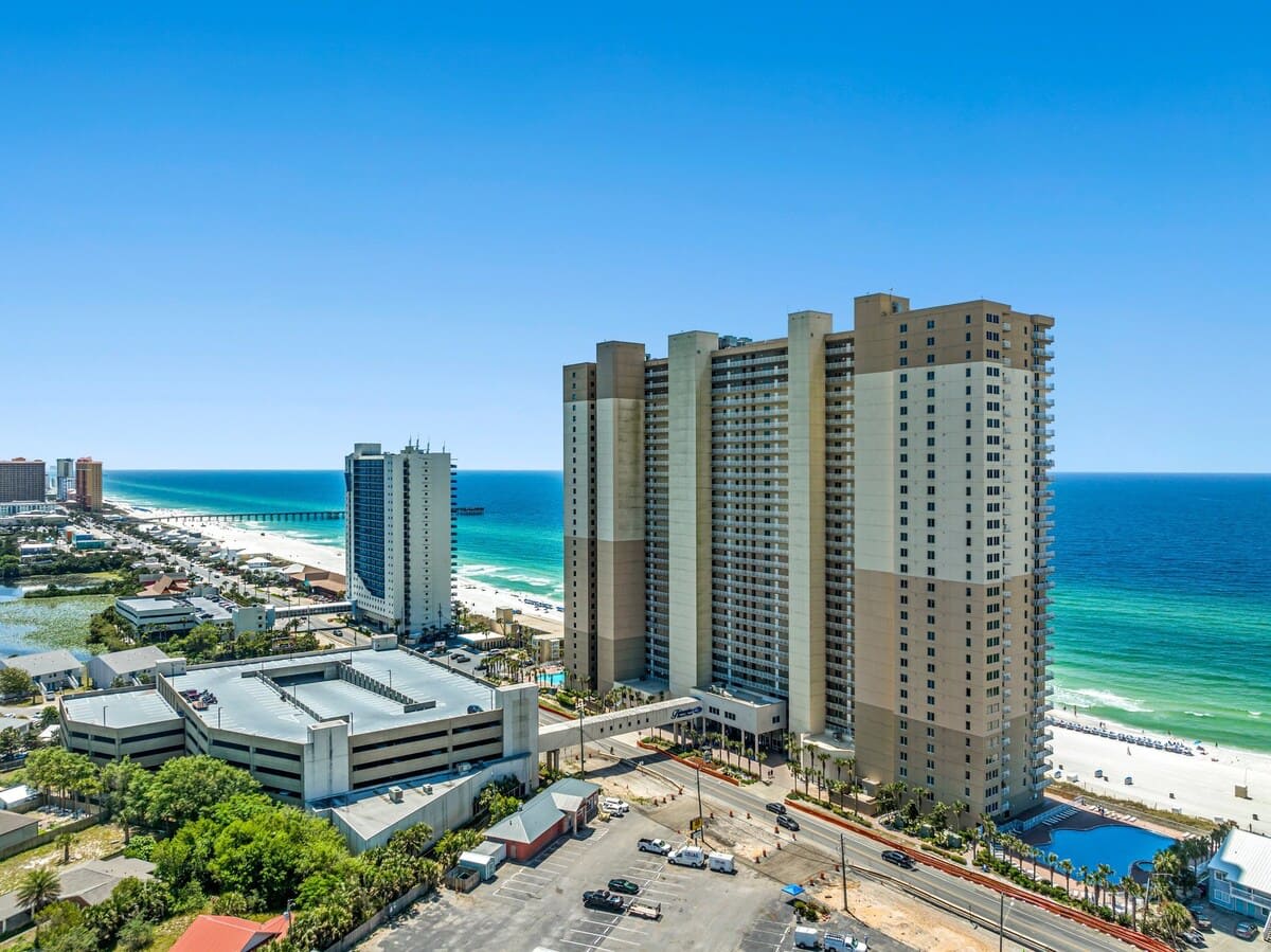Tidewater 200 – Aerial view of Tidewater 200, beachfront property with parking and ocean in the background.