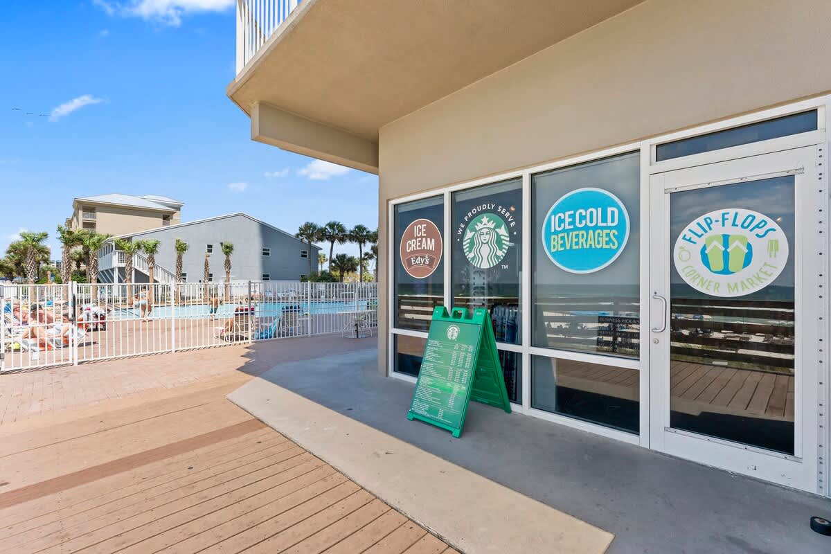 Tidewater 200 – Exterior view of a rental market with pool and palm trees in the background.