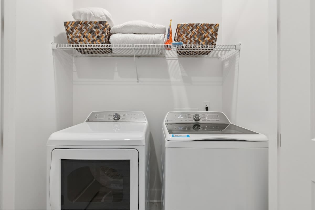 224 W Willow Mist Rd – Laundry room featuring a washer, dryer, and shelves with blankets and storage baskets.