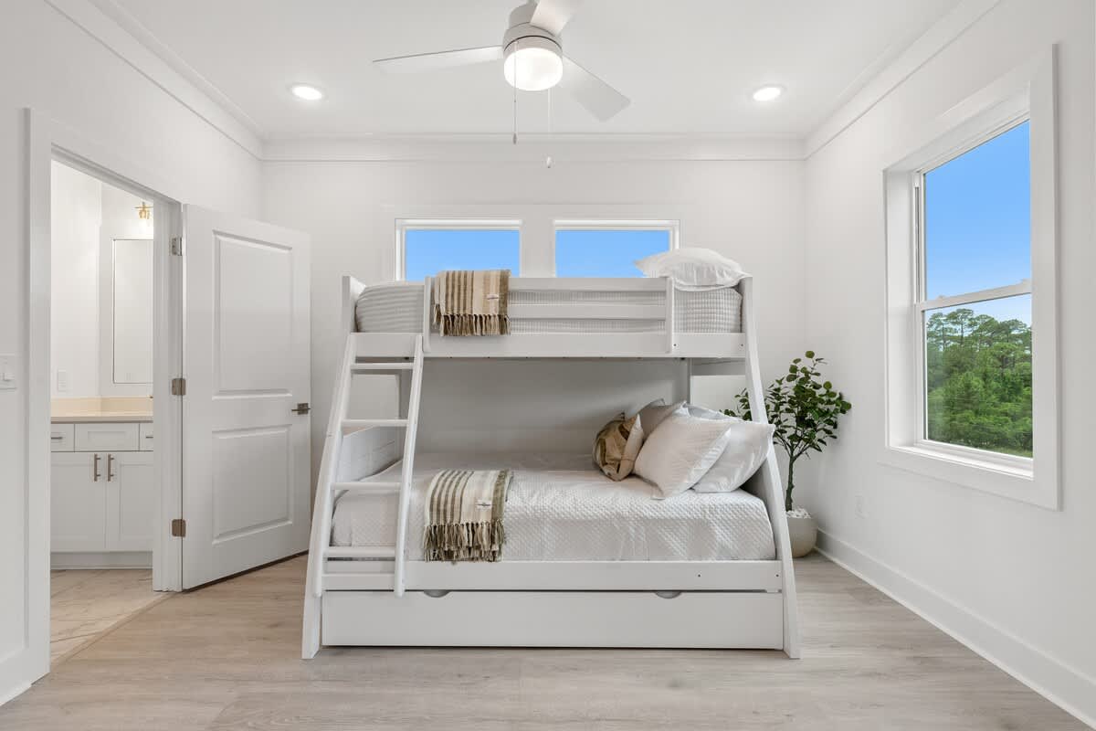 224 W Willow Mist Rd – Bright bedroom with a bunk bed, ceiling fan, and window view of greenery.