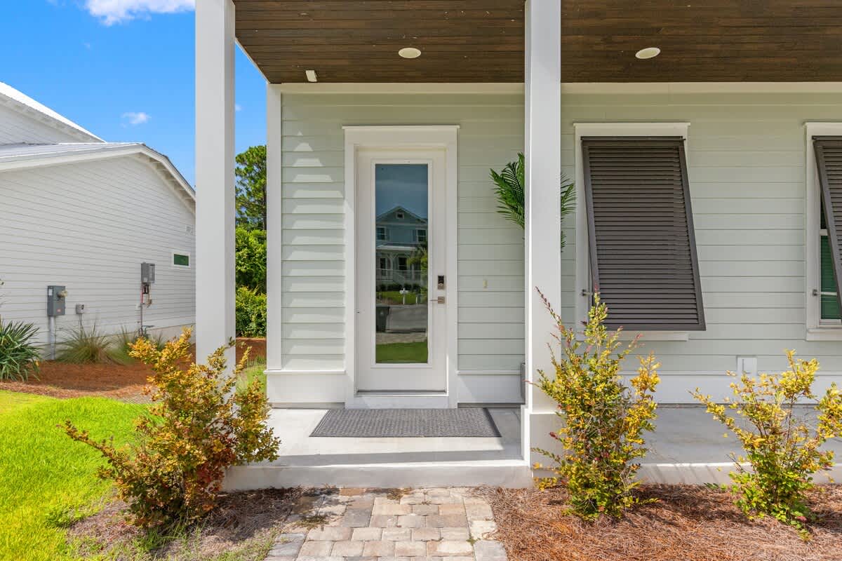 224 W Willow Mist Rd – Front entryway of a house with a door mat and landscaped shrubs.
