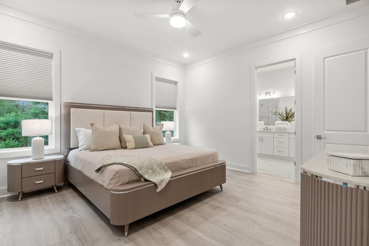 224 W Willow Mist Rd – Modern bedroom with a queen bed, bedside tables, and a bathroom doorway in the background.