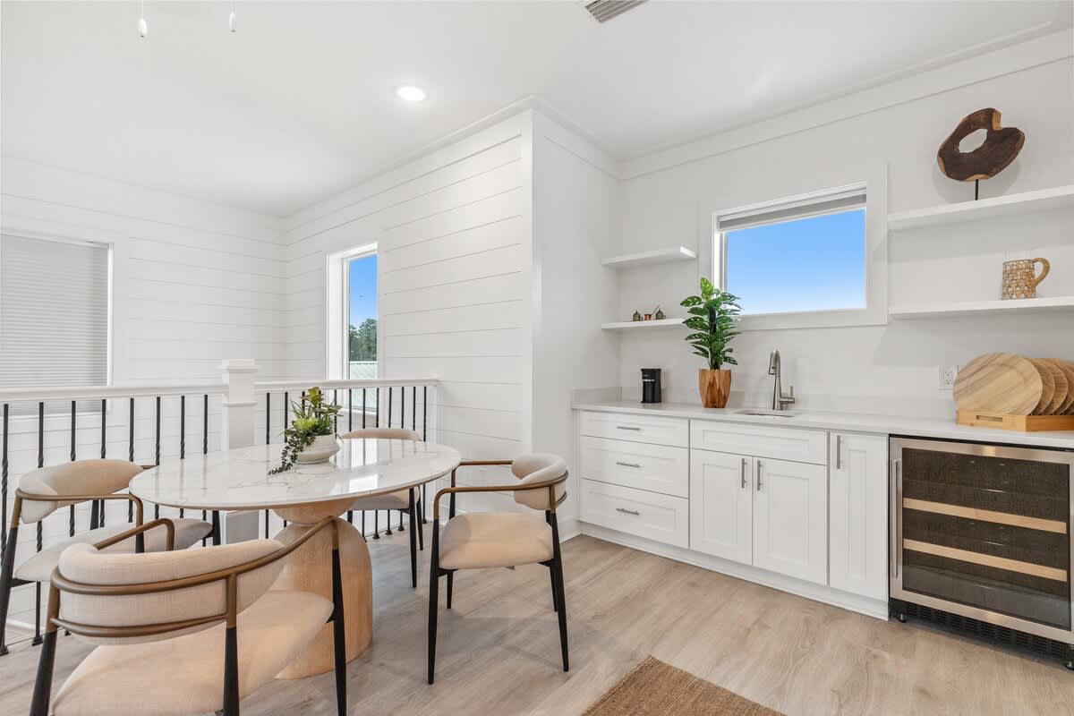 224 W Willow Mist Rd – Bright dining area with a round table, four chairs, and kitchen cabinetry featuring a small refrigerator.