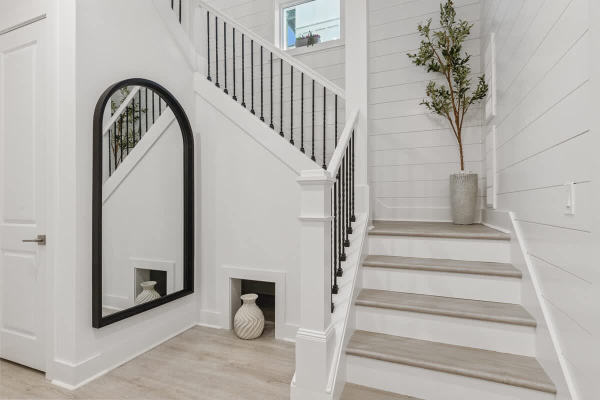224 W Willow Mist Rd – Interior entryway with staircase, large mirror, and potted plant against white shiplap walls.