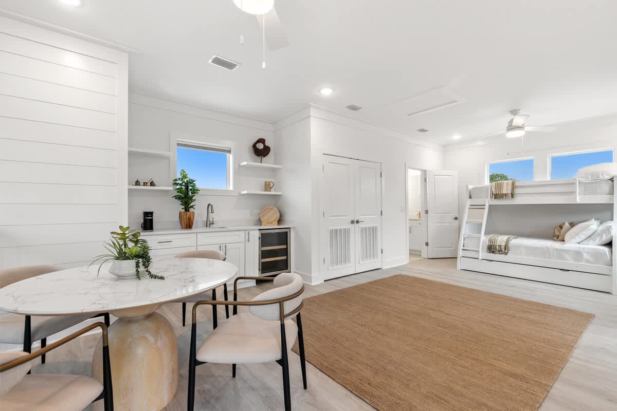224 W Willow Mist Rd – Bright room with a dining area, kitchenette, bunk beds, and natural light from windows.