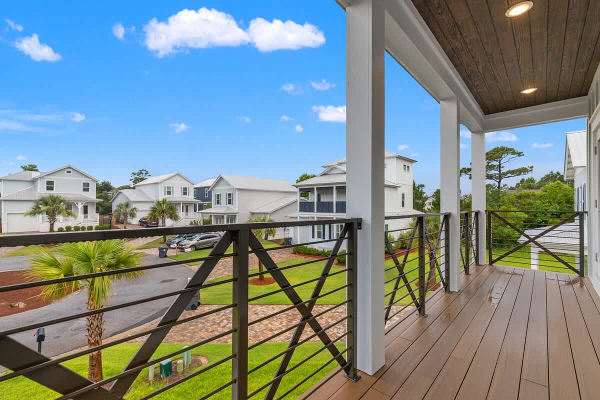 224 W Willow Mist Rd – View from a balcony overlooking nearby houses and landscaping, with a clear blue sky above.