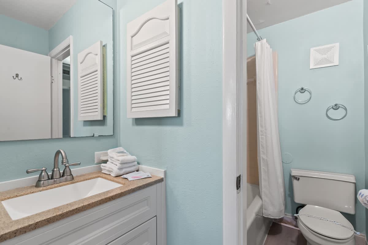 The Summit 315 – Bathroom with a light blue wall, sink, towels, and a shower/tub combo.
