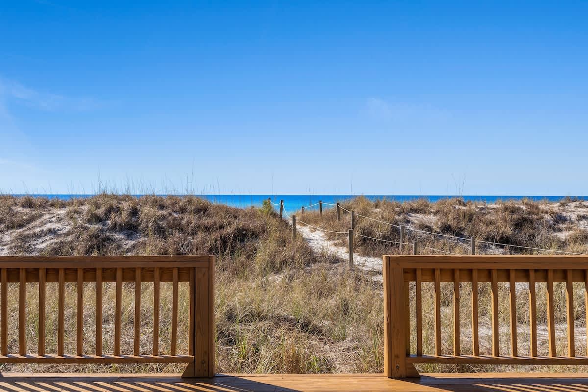 9620 Beach Blvd – View from a wooden deck overlooking sand dunes and the ocean path.
