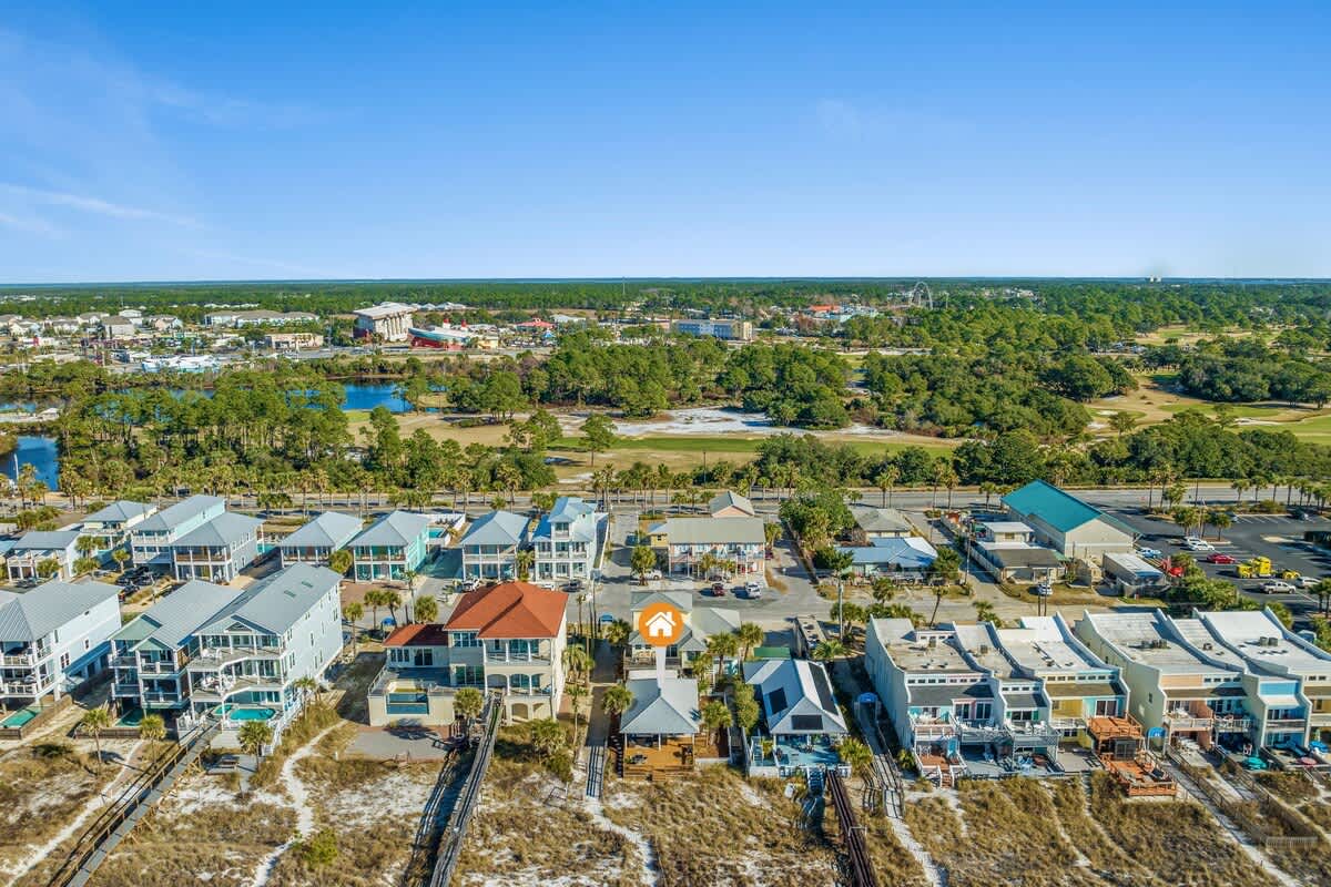 9620 Beach Blvd – Aerial view of beachside vacation rentals with nearby greenery and water features.