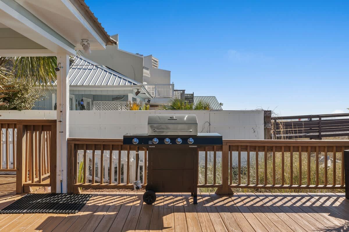 9620 Beach Blvd – Outdoor deck with a grill and view of nearby houses and landscaping.