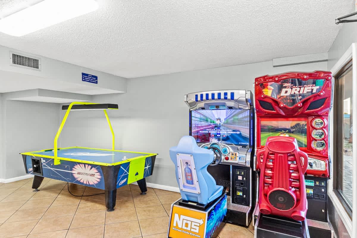 The Summit 1009 – Game room featuring air hockey table and two arcade racing games.