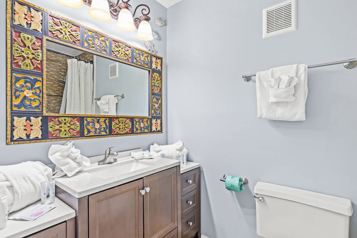 The Summit 632 – Bathroom with decorative mirror, double vanity, towels, and modern fixtures.