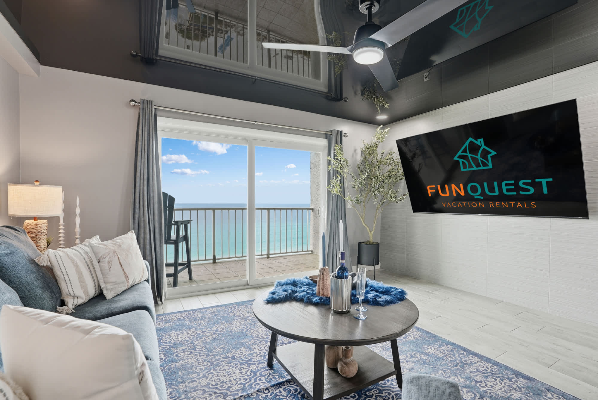 The Summit 1217 – Living room with ocean view, modern decor, sofa, coffee table, and television.