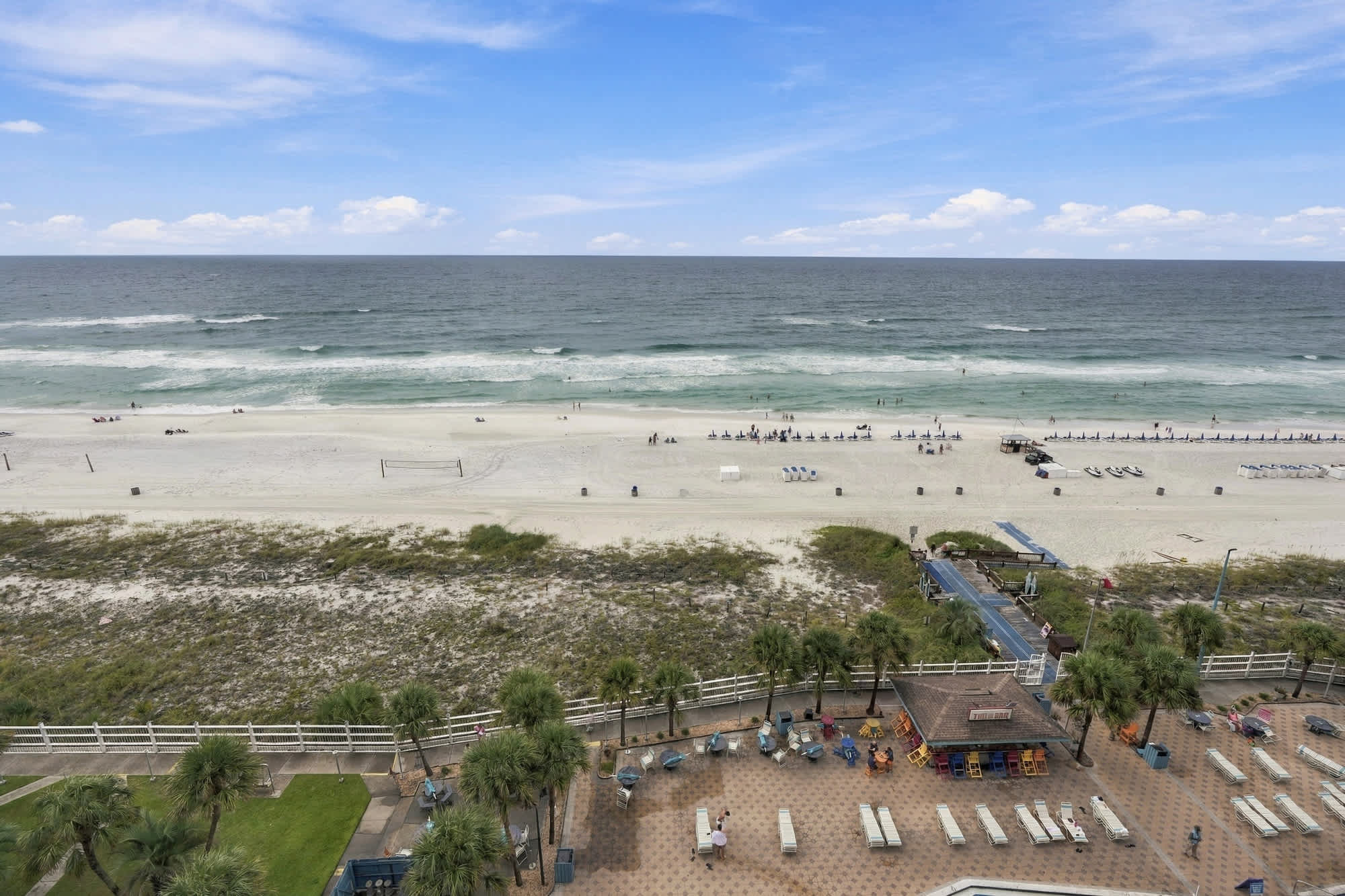 The Summit 1122  – View of the beach with sand, sea, and poolside lounge area at The Summit 1122.