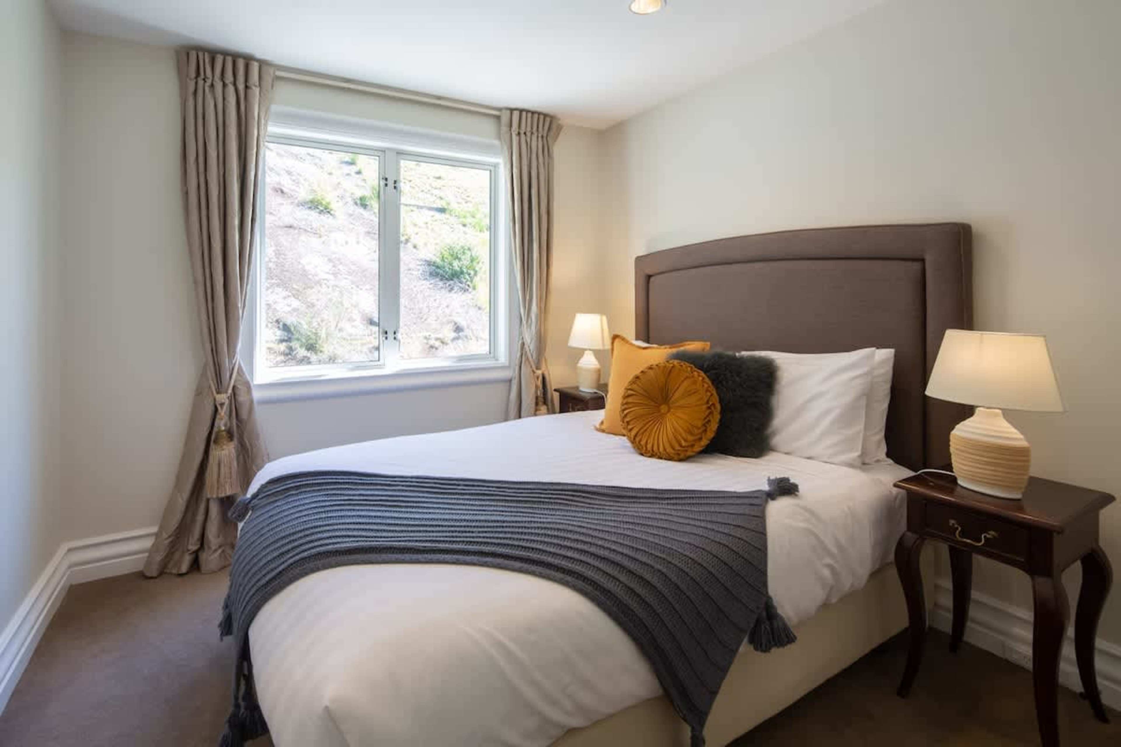 Comfortable Second Bedroom
Enjoy a restful night in the cozy second bedroom, featuring stylish decor and a peaceful atmosphere, perfect for unwinding after a day in Queenstown.
