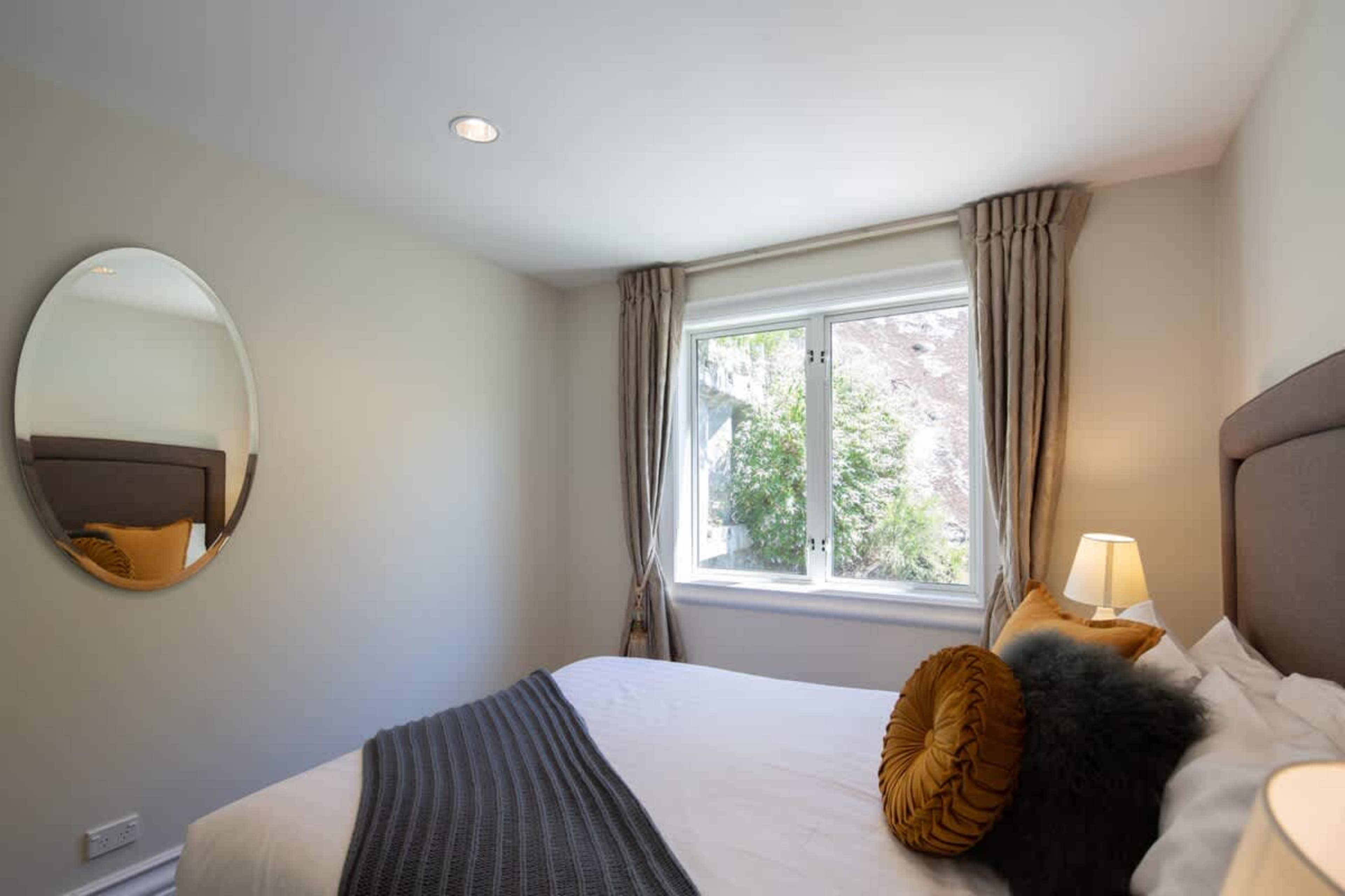 Inviting Second Bedroom
The second bedroom offers comfort and charm with soft linens and thoughtful touches, providing a tranquil retreat just steps from the lake and town center.